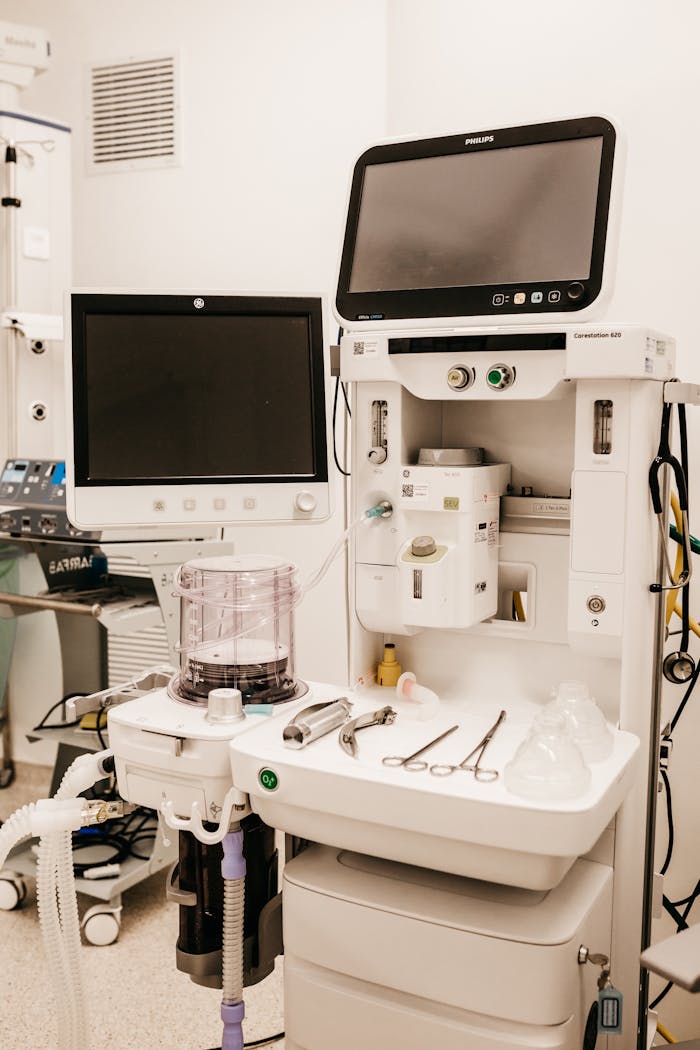 High-tech medical equipment setup in a hospital room, featuring monitors and surgical tools.