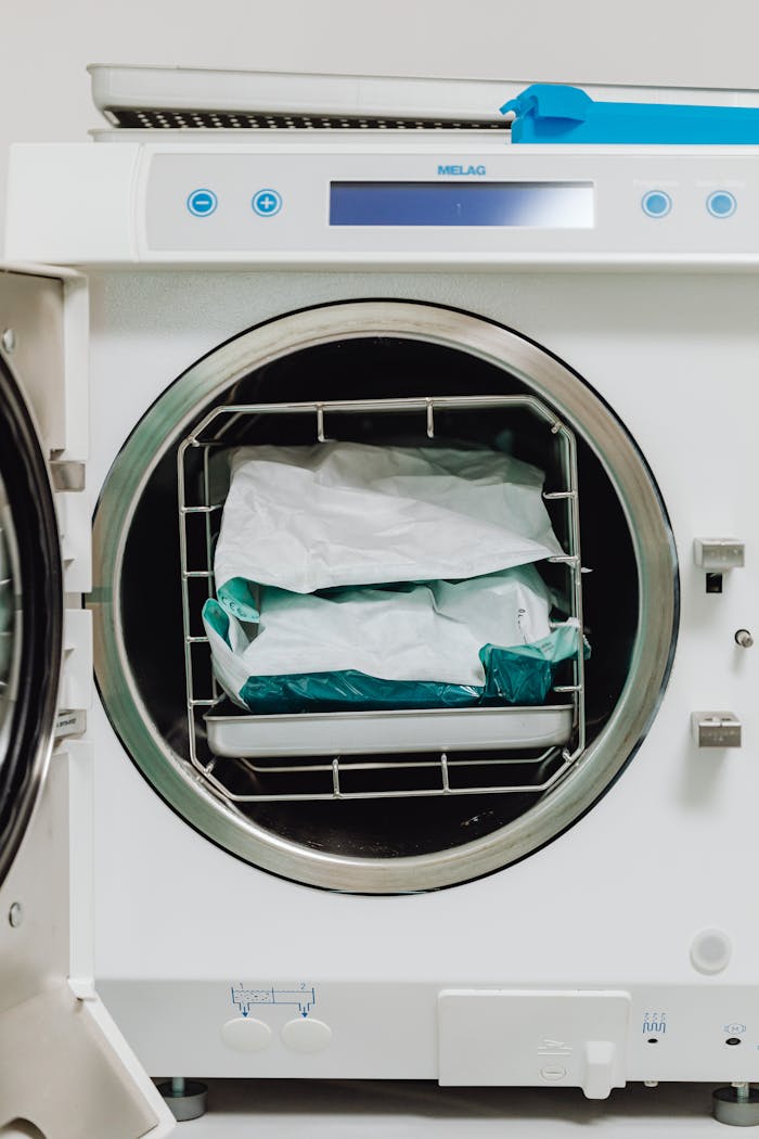 Medical sterilizer machine with sealed packages in a healthcare setting for hygiene processes.